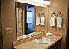 This is the upstairs hall bathroom by the stairs. It is shared by a queen bedroom across the hall and has one queen bedroom attached.