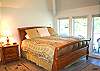 The upstairs master bedroom features a King Bed, full bathroom, walk-in closet, and balcony.