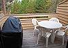 Upstairs deck with table and BBQ