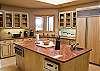 Another view of the kitchen and the oversized refrigerator.