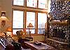 High end lodge furnishings and river rock fireplace.