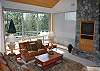 The Great room has great views through the back wall of windows. It also has a nice river rock fireplace and room for all of the family.