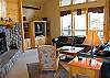 Another view of the living room. Big windows and high vaulted ceilings.