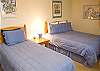 This bedroom is located at the top of the stairs and offers sleeping with twin and queen beds.