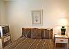 Downstairs has two bedrooms. One with a Queen Bed and another with a set of Bunk Beds, both have their own TV's.