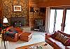 Cozy leather furniture and a wood burning fireplace create the perfect space to relax after a day in the great outdoors.