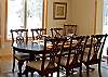Dining table seats 8 people with additional seating at kitchen bar.