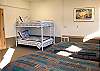 A great place for the kids to get away in this bedroom off of the airplane hangar.