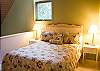 Upstairs loft with a queen bed.  There is a bathroom upstairs.