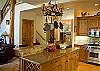 This kitchen is beautiful, with granite countertops and all stainless steel  appliances.