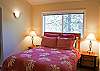 Nicely decorated upstairs Queen Bedroom with pretty wooded view.