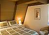 The downstairs bedroom features a Queen Size Bed.  The bathroom is right next door in the hallway.