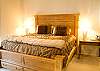 Master Bedroom features a stately Kind Size Bed.  Lofty pillow top mattress provides sweet dreams leading to peaceful mornings.