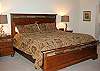 Relax in this large King Master Suite with a chair, two rockers, walk-in closet, TV, VCR, and bath with separate shower.