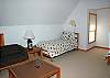 Kids can have their separate space in this good sized loft bedroom with 2 twin beds, couch, coffee table, TV/VHS and bathroom.