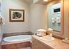 Downstairs master bathroom features a deep jacuzzi tub!