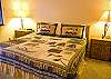 This Kiing bedroom is in the hallway by the kitchen. It shares a hall bath.