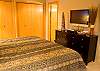 Another view of the King Master with a flat screen t.v. and master bath.