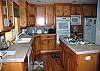Beautiful wood cabinets and tile counter tops accent this kitchen nicely.