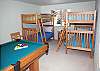 Downstairs Bunk Room.  Also included in this room is a non-regulation sized pool table and sitting area with a TV.