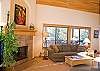 Large living room with high ceilings and lots of windows.