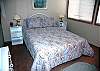 The third bedroom features a queen size bed, and has a TV.  It shares a hall bathroom.  This bedroom is to the left of the living room.
