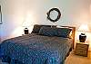 This Master King Bedroom has a sliding door which leads to a deck with a view of Aspen Lake and mountains.