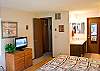 King Master Bedroom Downstairs with flat screen TV.