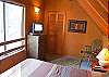 Queen Size Bed in loft with  nice view of pine trees, deck and hot tub.  Very comfortable space!