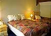 Cozy bedroom with one Full and one Twin Bed.  Shares hall bathroom.  This bedroom has a TV.