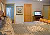 Another view of King Master Bedroom that is downstairs with flat screen TV.