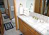 The upstairs has a double bath.  Each side has its own sink and mirror and shares the bathroom with the two upstairs bedrooms.