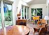 This sunroom features a foos ball table and ample space for lounging in the warm sunshine.