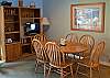 A dining table provides ample seating for the entire family during meal times.