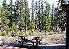 Patio table with relaxing wooded view.