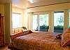 The master bedroom downstairs has a King Size Bed, Full Bathroom, walk-in closet, and a door to the patio.