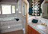 The master bathroom is quite spacious and has been newly remodeled. In the evening light some candles and soak to your hearts content.