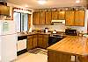 A fully stocked and organized kitchen is ready and waiting for you to use.