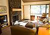 Beautiful rock fireplace with comfortable couches are ready for a fire and football or feet up and watching the golfers go by. This condo has something for everyone.