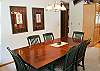 Large dining table is open to the kitchen and living room.