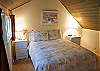 Light and bright, the upstairs bedroom features a Queen Size Bed with a bathroom just across the hallway.