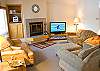 In this light and bright Living Room, gather family and friends to enjoy a cozy fire while watching your favorites on this the large flat screen TV.