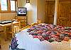 Another view of Upstairs Queen Bedroom with game table and TV.