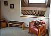 Sitting chair in loft with the Pyramid Bunk.