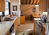 Galley kitchen with lots of counter space and opens to the dining area.