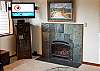 Living room with fireplace and flat screen TV.