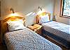 Twin Bedroom has TV and access to hall bathroom with tub/shower.