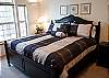 Sunny and bright, this front bedroom features a Queen Size Bed and a TV.