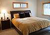 This King Master Bedroom features a King Size Bed with bathroom, walk-in closet, TV, and a patio door leading to the hot tub.