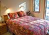 Queen Bedroom has TV and access to hall bathroom with tub/shower.